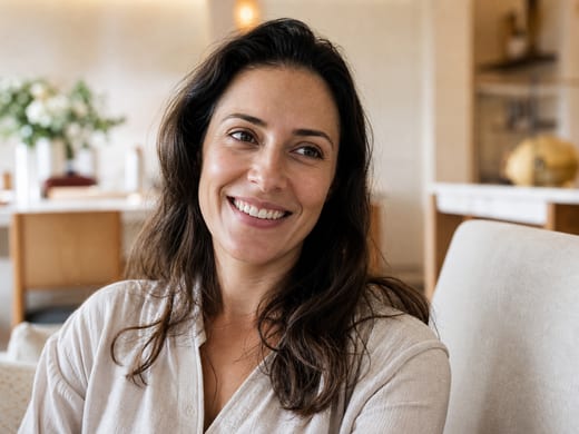 A patient smiling naturally in the practice consulting room